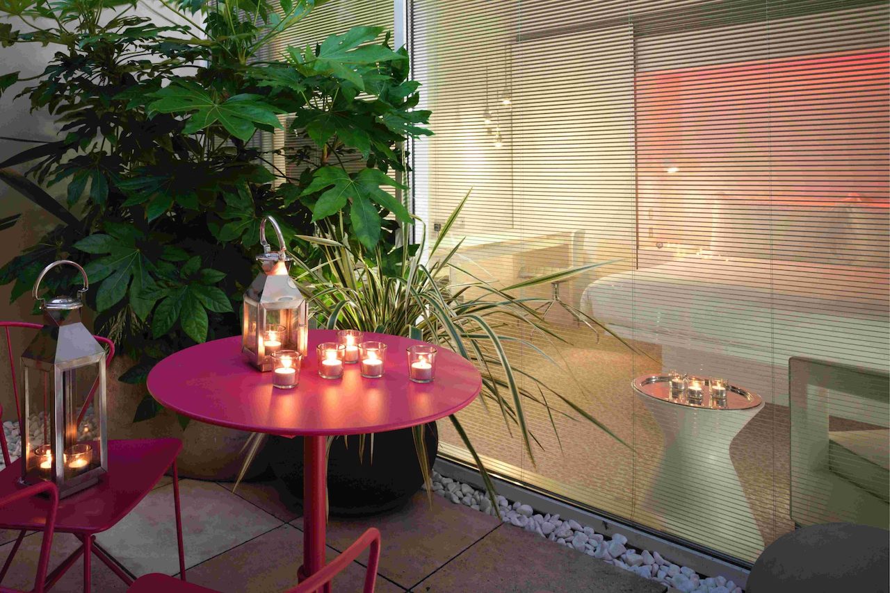 Outdoor garden terrace with pink table and candles