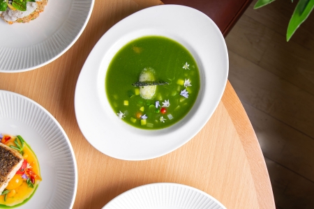 Green soup in a white bowl