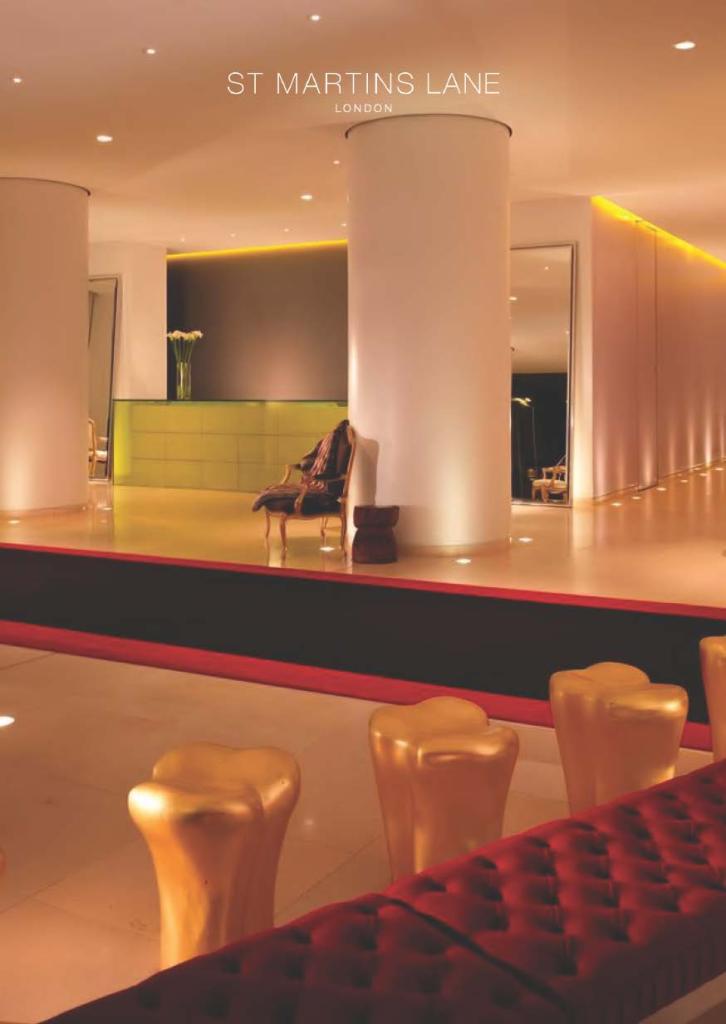 Image of large lobby with gold figures, red benches, and light warming