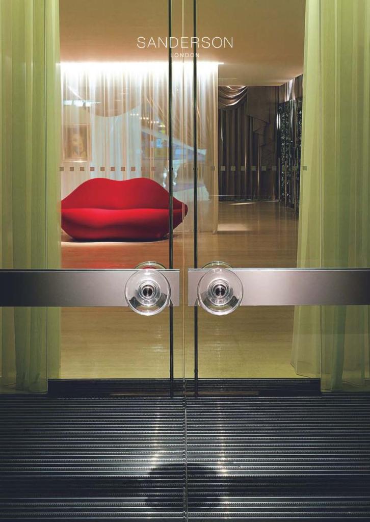 Glass lobby doors with red lip sofa beyond the glass