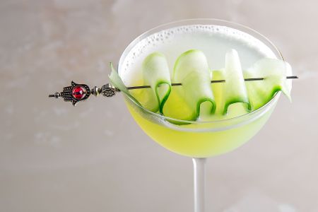 Close up image of cucumber cocktail in a stemmed glass