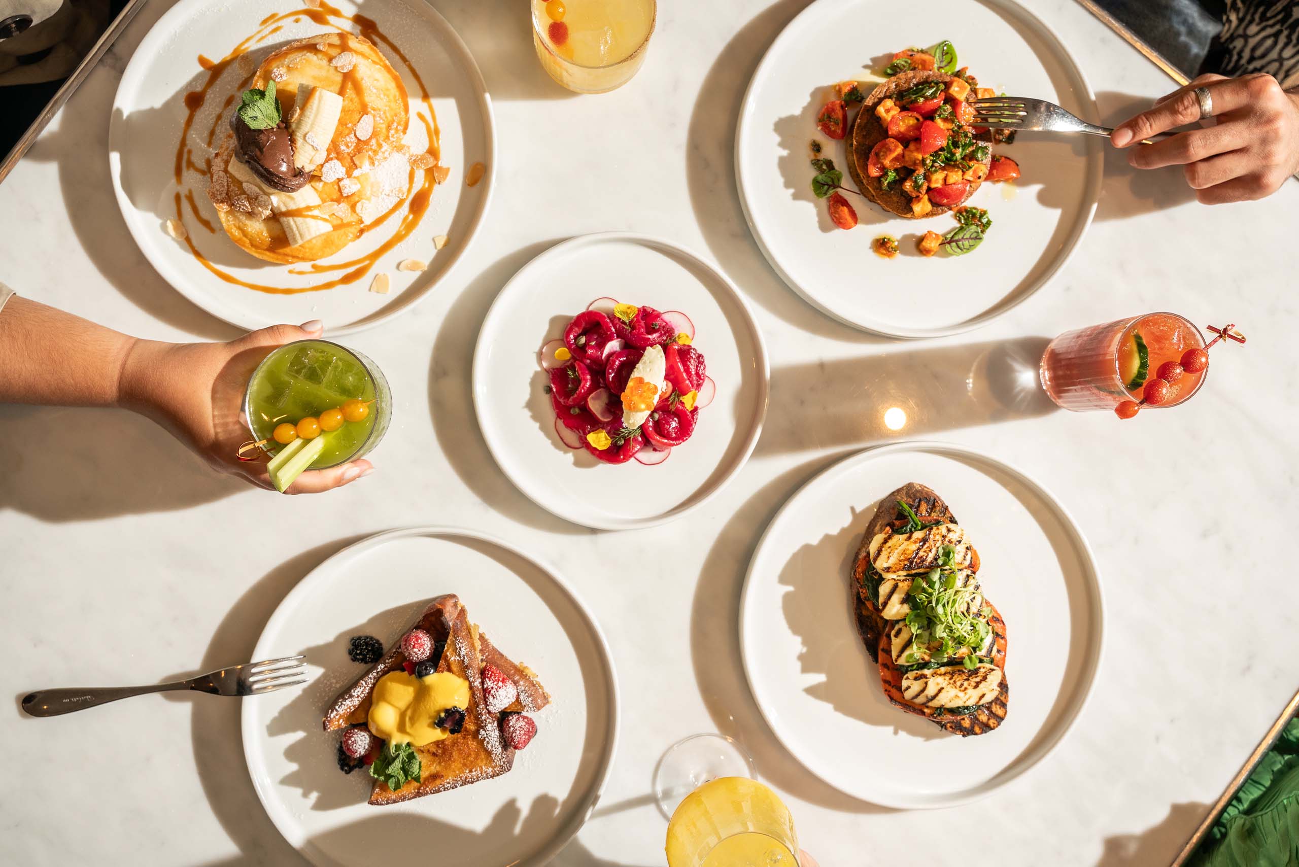 Table with several breakfast dishes. 