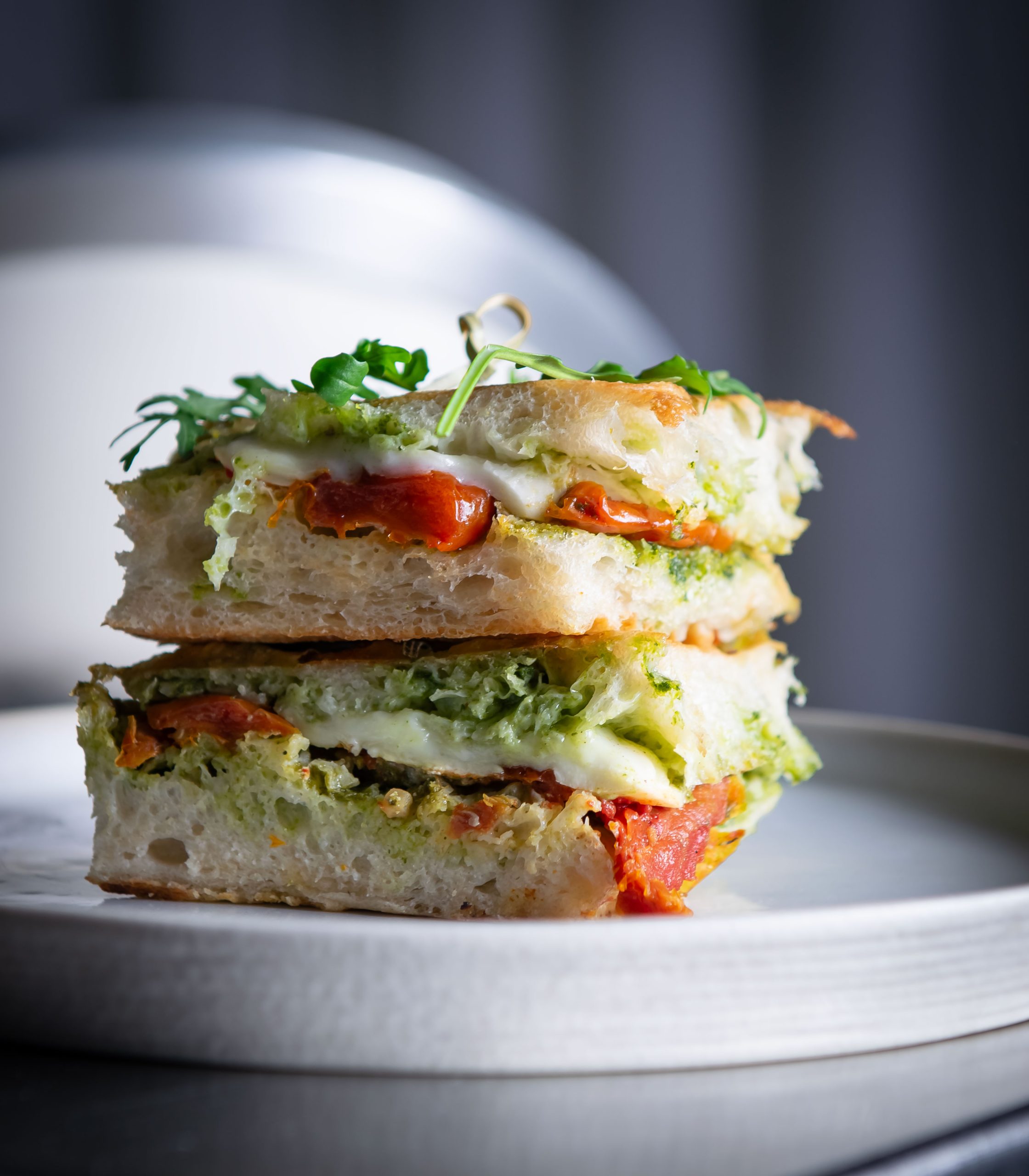 Focaccia sandwich with sun-dried tomatoes, mozzarella and pesto 