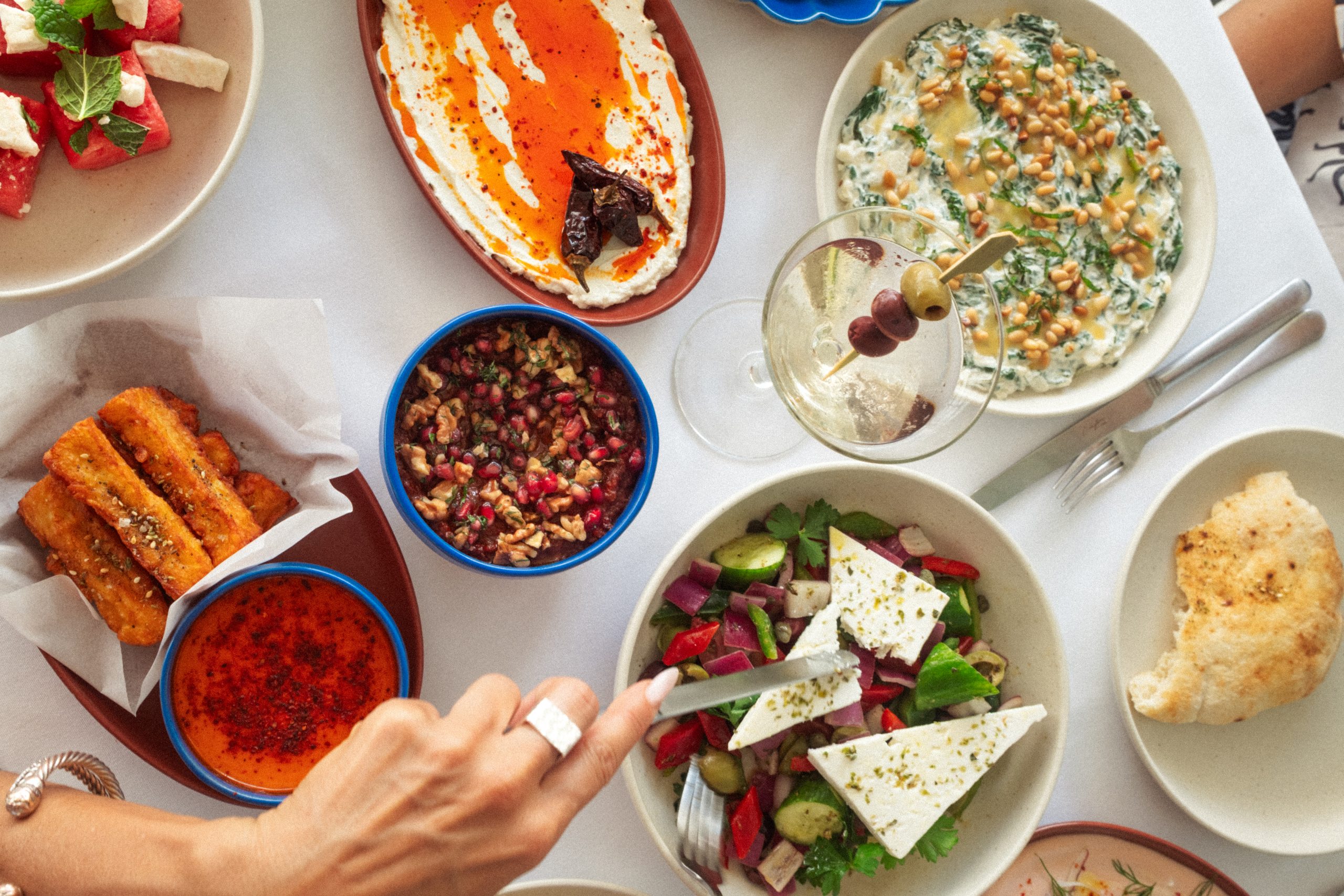 able setting at Cleo Restaurant showcasing a variety of Mediterranean-inspired dishes