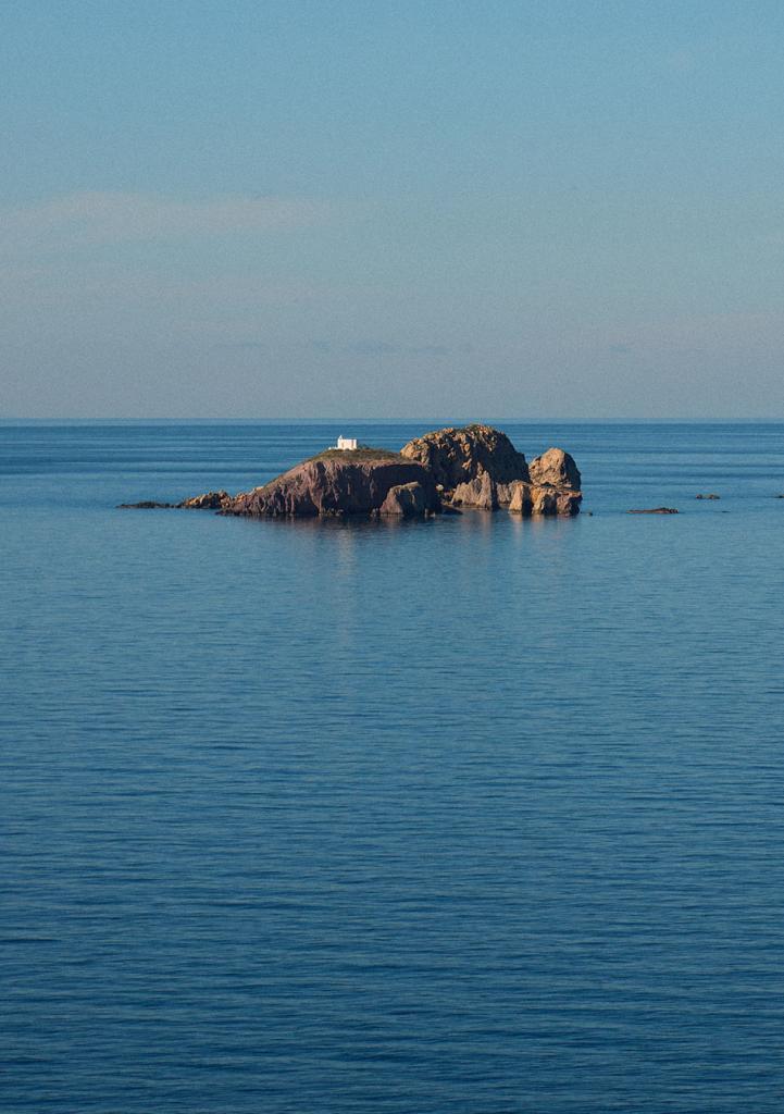 small rock in the blue sea water