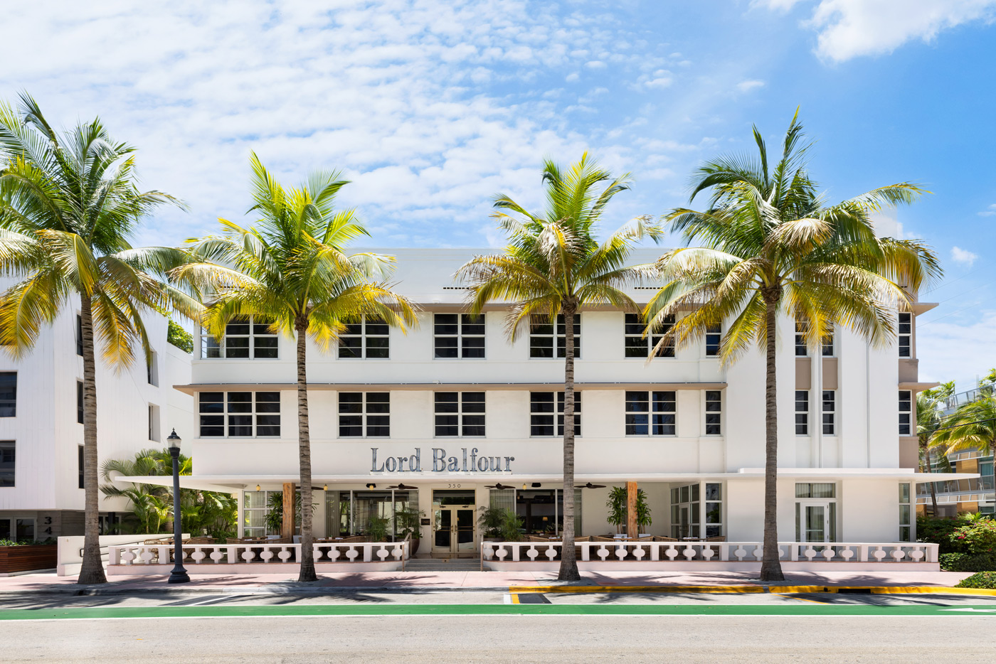 exterior of the Balfour hotel in Miami with palm tress and blue sky