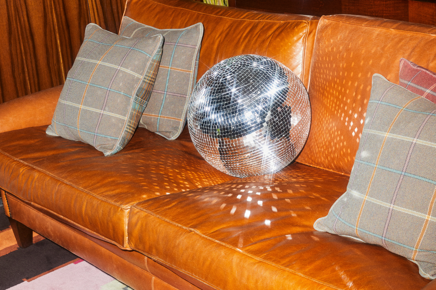 Christmas at St Martins Lane. Christmas event in the Den. Disco ball on the sofa.